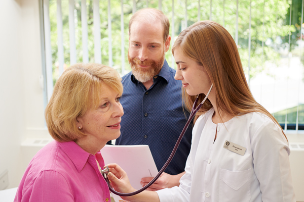 CCNM operates several naturopathic teaching clinics A male naturopathic doctor supervises a female intern with a female patient
